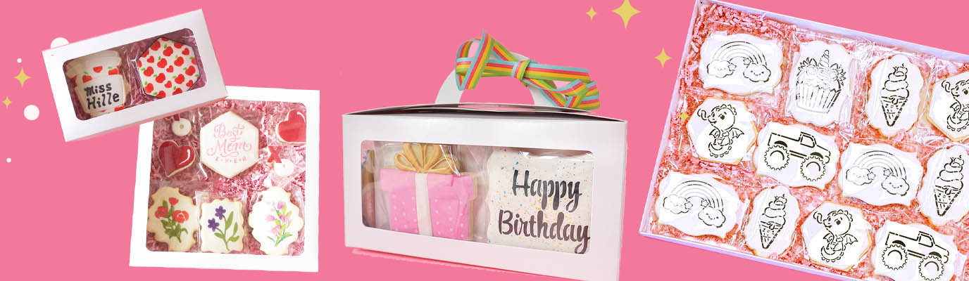 A white box with a handle that has birthday cookies in it. 